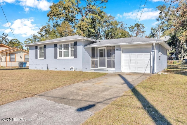 view of front of house with a garage, a front lawn, and a sunroom