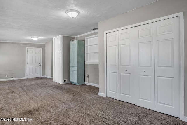 unfurnished bedroom with carpet floors and a textured ceiling