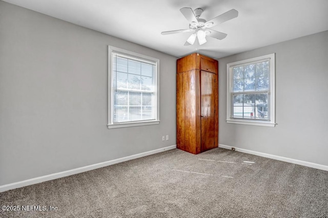 unfurnished bedroom featuring ceiling fan, light colored carpet, and multiple windows