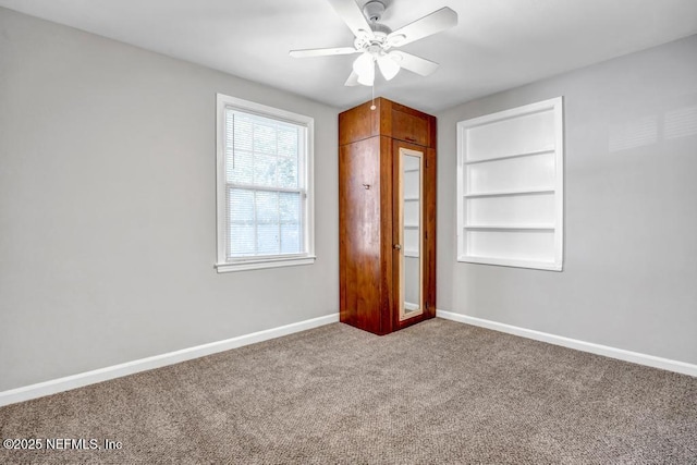 unfurnished bedroom featuring ceiling fan and carpet floors