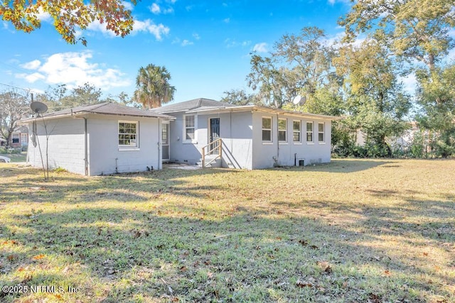 back of house with a lawn