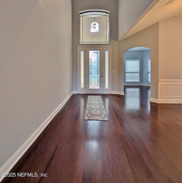 foyer featuring dark hardwood / wood-style flooring and a high ceiling