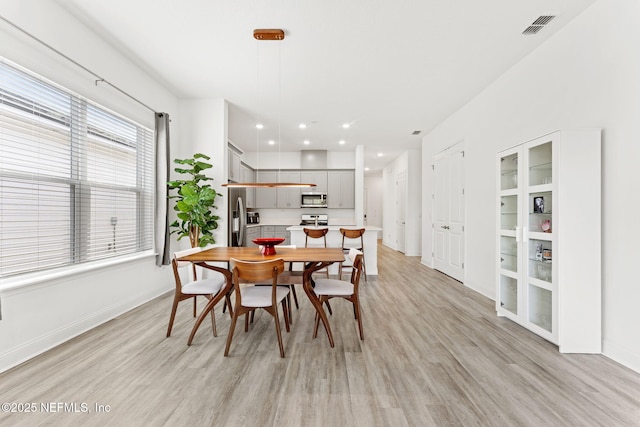 dining area with light hardwood / wood-style flooring