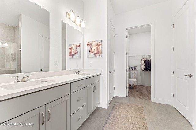 bathroom with tile patterned flooring, vanity, and an enclosed shower