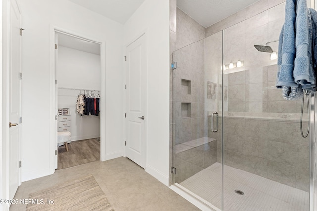 bathroom with tile patterned floors and walk in shower