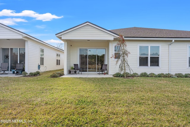 rear view of property with a lawn and a patio area