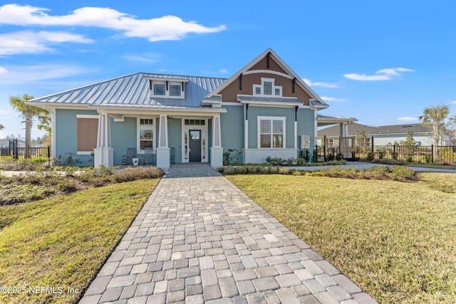 view of front of home featuring covered porch and a front lawn