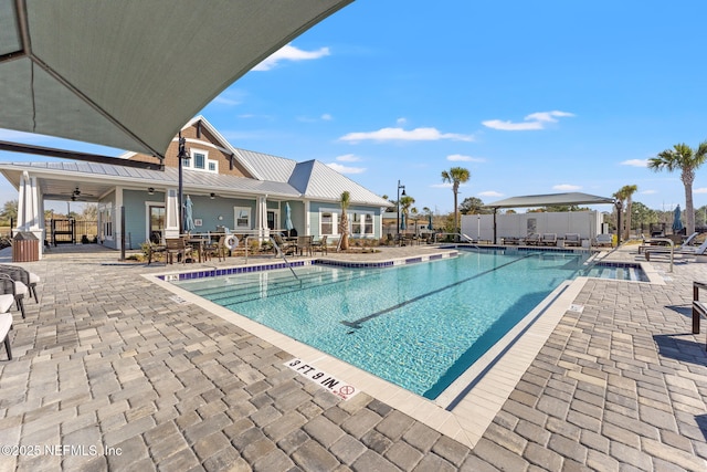 view of pool featuring ceiling fan and a patio