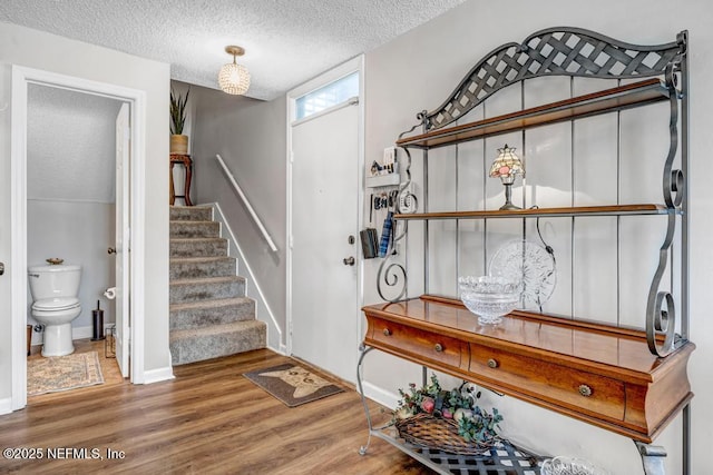 foyer with wood-type flooring and a textured ceiling