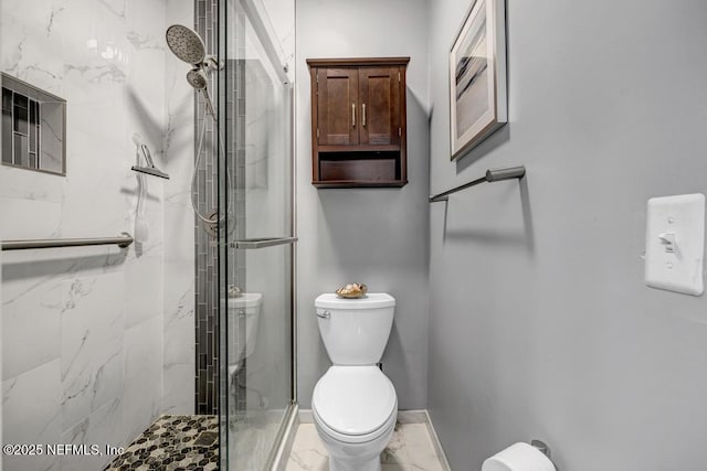 bathroom with a shower with door and toilet