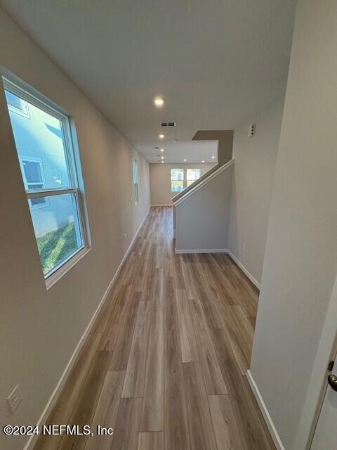 corridor with light hardwood / wood-style flooring