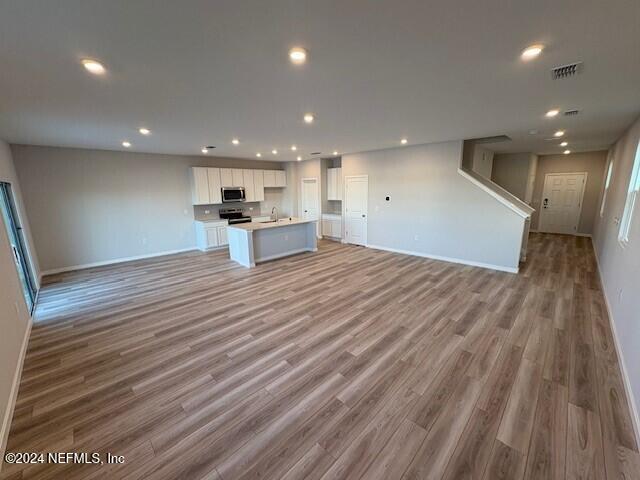 unfurnished living room featuring light wood-type flooring