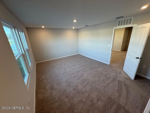 unfurnished room featuring carpet flooring