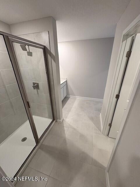 bathroom featuring vanity and a shower with shower door