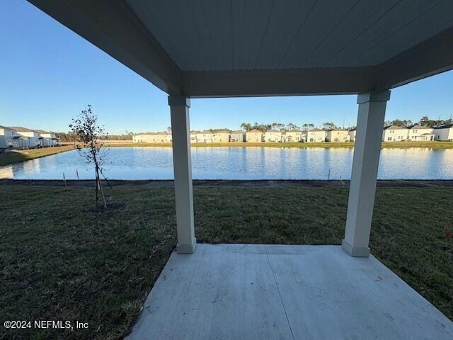 view of yard featuring a patio area and a water view