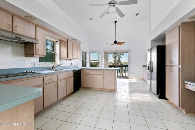 kitchen with ceiling fan, sink, light brown cabinetry, light tile patterned flooring, and black appliances