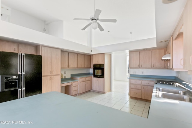 kitchen featuring black appliances, light tile patterned floors, sink, and light brown cabinetry