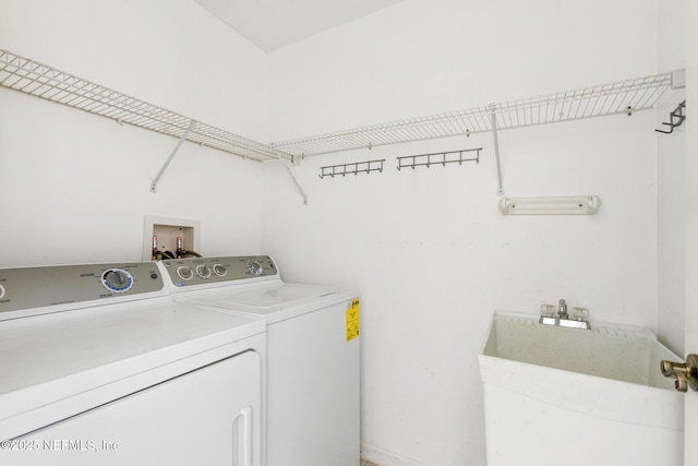 laundry area with washer and clothes dryer and sink