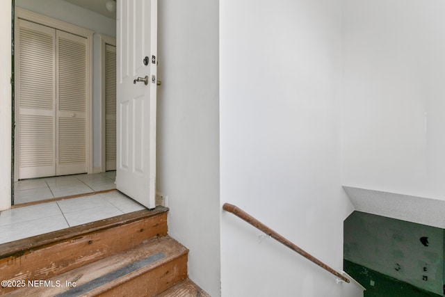 stairway featuring tile patterned flooring