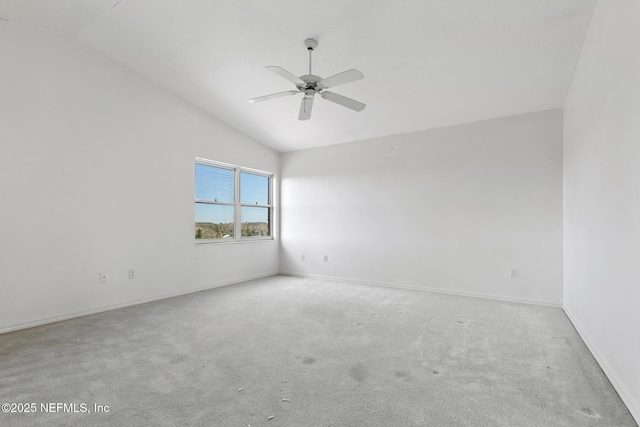 carpeted empty room featuring ceiling fan and lofted ceiling