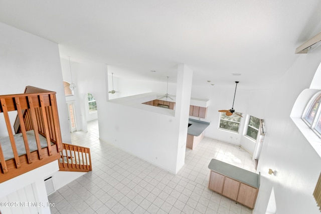 living room featuring ceiling fan and high vaulted ceiling