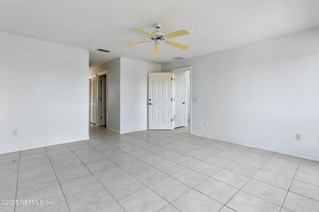 tiled empty room with ceiling fan