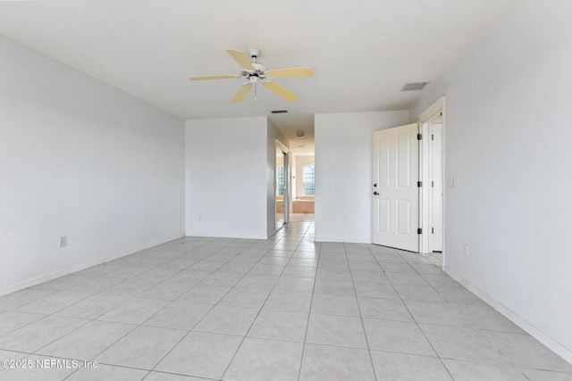 tiled spare room with ceiling fan