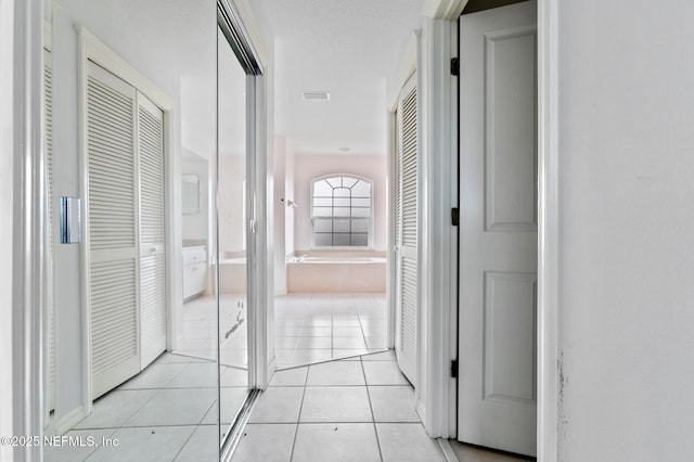 corridor with light tile patterned floors