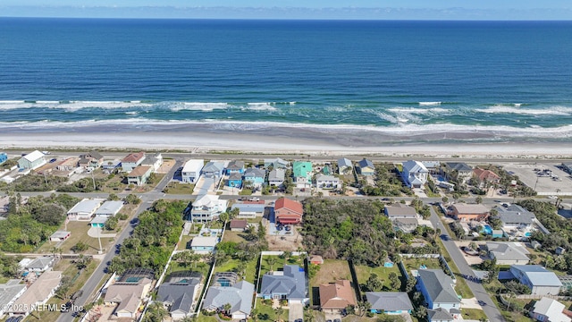 bird's eye view with a water view and a beach view