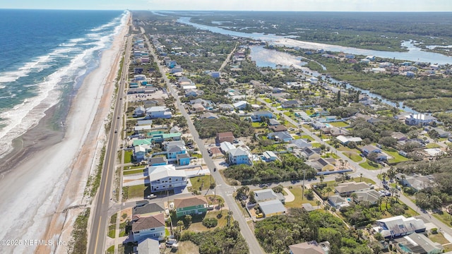 aerial view with a water view and a beach view