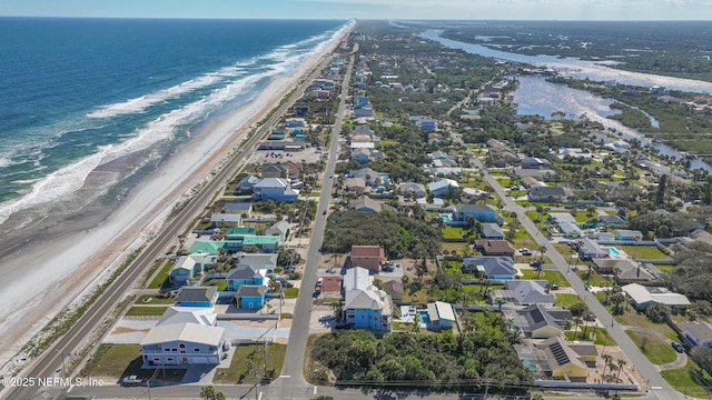 aerial view featuring a view of the beach and a water view