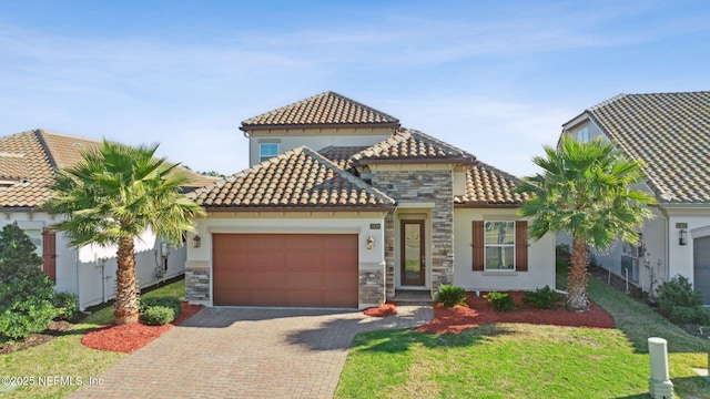 mediterranean / spanish-style house with a garage and a front lawn