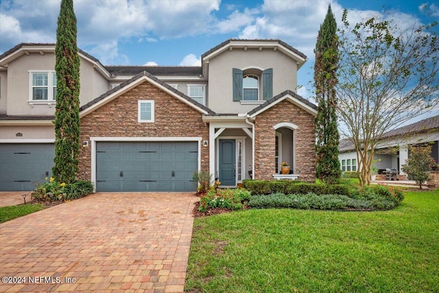 view of front of property featuring a garage and a front yard