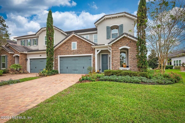 view of front of house with a garage and a front lawn