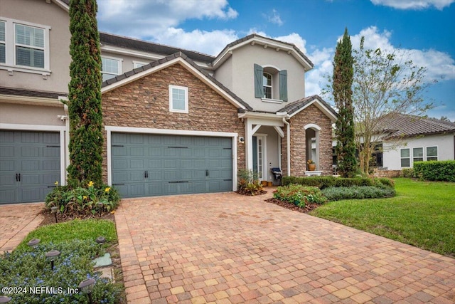 view of front facade featuring a front yard and a garage