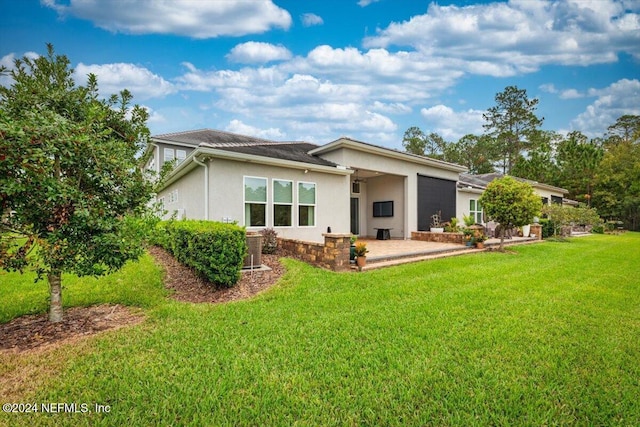 back of property featuring a patio area and a yard