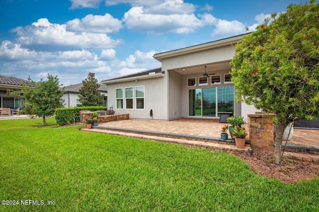 rear view of house featuring a lawn, a patio area, and ceiling fan