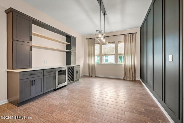 interior space with hanging light fixtures and beverage cooler