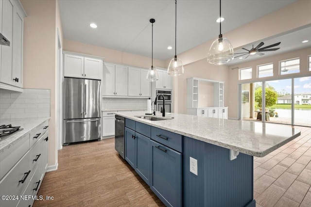 kitchen featuring decorative backsplash, ceiling fan, white cabinetry, and stainless steel appliances