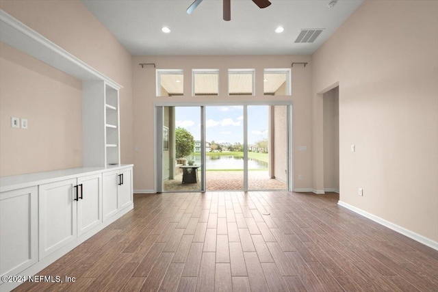 spare room with ceiling fan and a water view