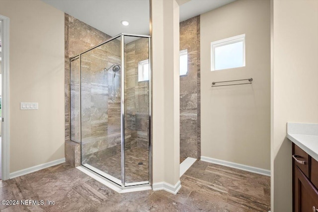 bathroom featuring a tile shower and vanity