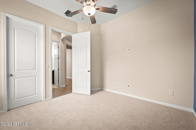 unfurnished bedroom with light carpet and ceiling fan