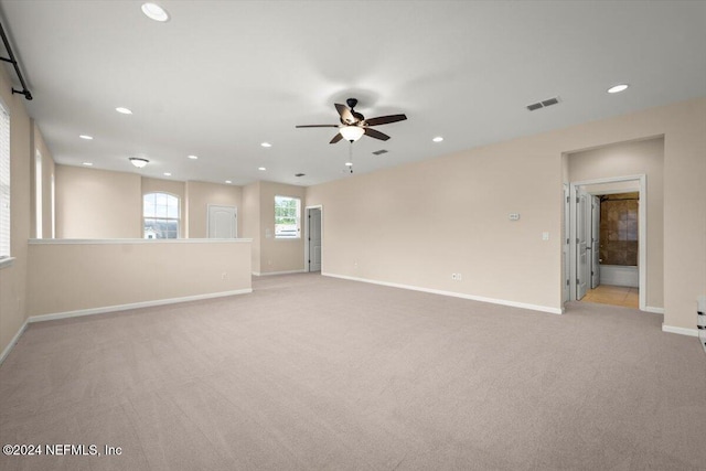 empty room featuring light carpet and ceiling fan