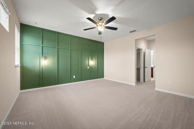 unfurnished bedroom with light carpet and ceiling fan