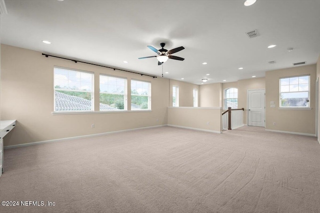 unfurnished room featuring ceiling fan and light colored carpet