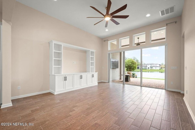 unfurnished living room featuring ceiling fan