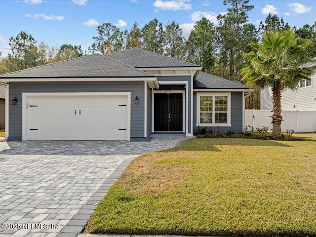 view of front of house featuring a garage and a front lawn