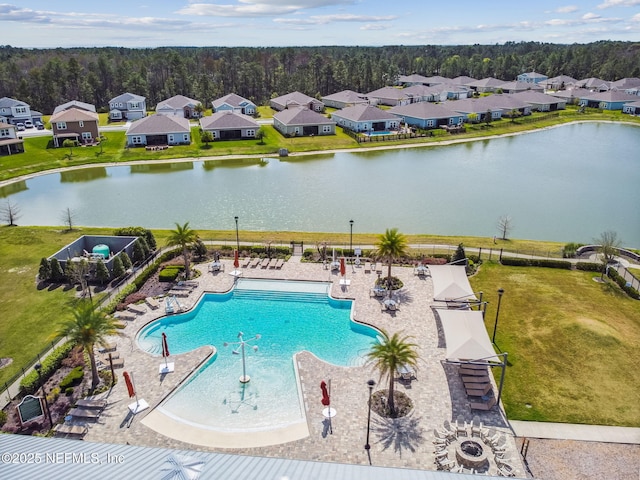 view of swimming pool with a patio and a water view