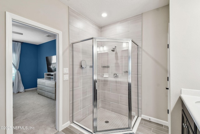 bathroom with walk in shower and vanity