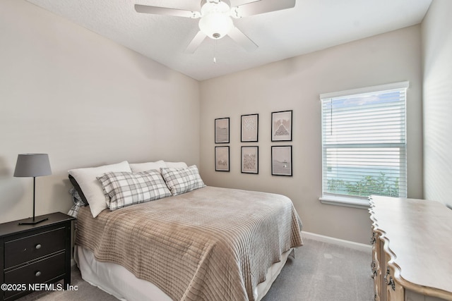 bedroom with ceiling fan and light carpet